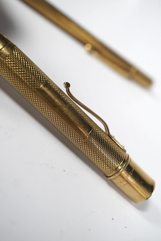 Two engine turned 9ct gold pencils, hallmarked for London, 1959 and London, 1969, both approx. 11.8cm. Condition - fair to good